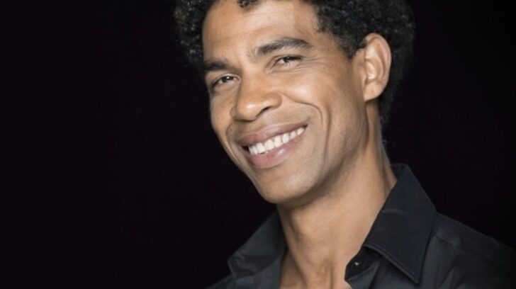 Carlos Acosta Cuban-British director and ballet dancer headshot in black shirt