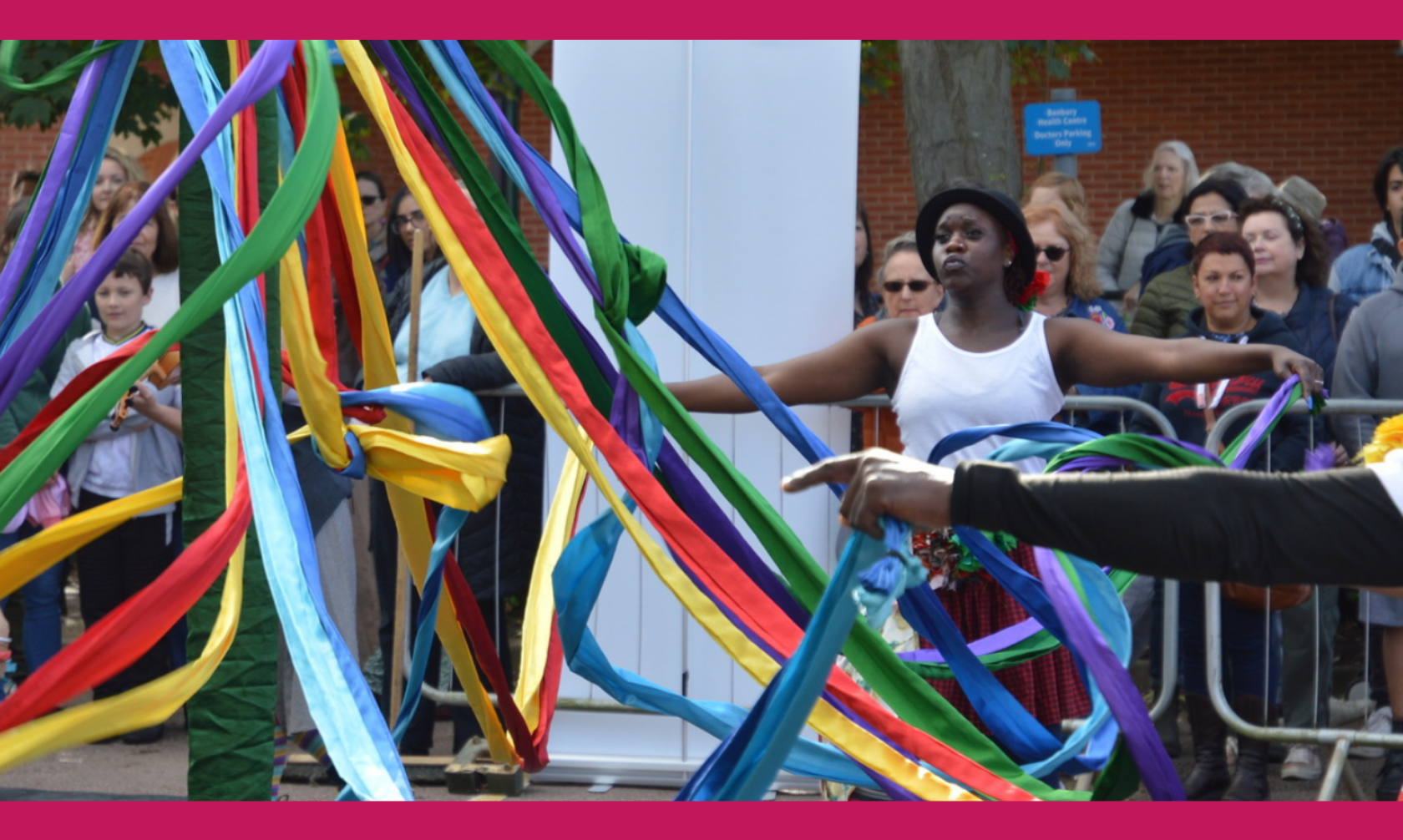 animated dancers with coloured ribbons around a maypole