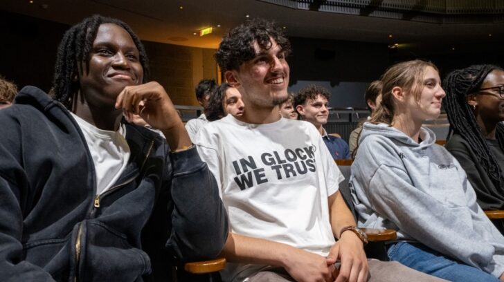 Young adult audience members smiling and laughing